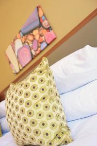 a yellow bag sitting on top of a bed at The White Lion Hotel in Aldeburgh
