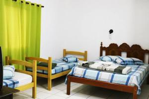 En eller flere senge i et værelse på Hotel Colonial Bragança Paulista
