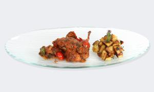 a plate of food with meat and french fries at Hotel Capizzo in Ischia