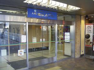 an entrance to a shopping mall with revolving doors at Ageo Tobu Hotel in Ageo