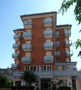 a building with balconies on the side of it at Hotel Caesar in Pesaro