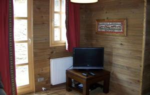 a television sitting on a table in a room at Odalys Chalet Melusine in L'Alpe-d'Huez