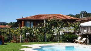 a house with a swimming pool in the yard at Quinta Travessa in Vieira do Minho