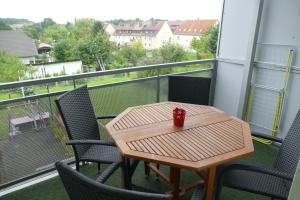 a small table and chairs on a balcony with a view at Fewo Am Messepark in Löbau