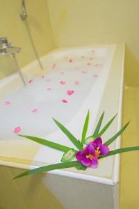 a purple flower sitting on top of a bath tub at Inle Apex Hotel in Nyaung Shwe