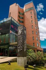 a building with a sign in front of it at Hotel Casa Victoria in Medellín