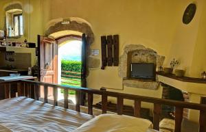 a bedroom with a doorway with a tv and a balcony at Elia House in Megála Khoráfia