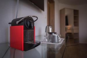 a black and red appliance sitting on top of a counter at B+B Passifleur in Delémont