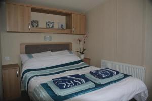 A bed or beds in a room at Weymouth Family Caravans