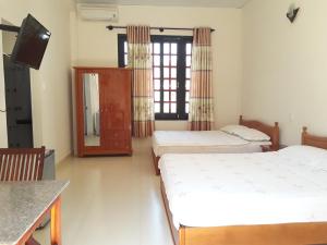 Giường trong phòng chung tại Ngoc Sang Guesthouse