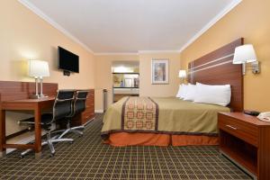 a hotel room with a bed and a desk at Americas Best Value Inn - Azusa/Pasadena in Azusa