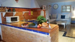 a kitchen with a counter with fruits and vegetables on it at Carmen De Arnas in Colungo