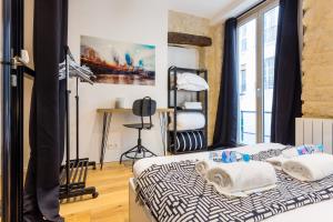 a bedroom with two beds and a window at CMG Montorgueil X in Paris