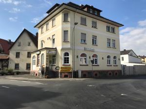 a large white building on the corner of a street at Hotel Anker in Großenlinden