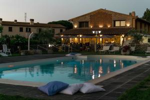 a swimming pool in front of a house at Azienda Agrituristica Il Poggetto Delle Spighe in Collesalvetti