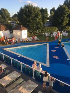 a group of people standing around a swimming pool at Rockley Park Private Holiday Homes in Poole