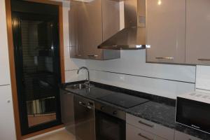 a kitchen with a sink and a counter top at Costa Reinante Spa in Barreiros