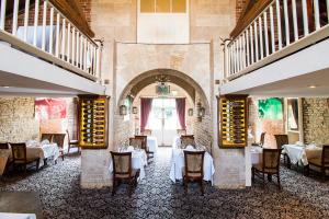 a restaurant with tables and chairs in a room at Normanton Park Hotel, Sure Hotel Collection by Best Western in Oakham