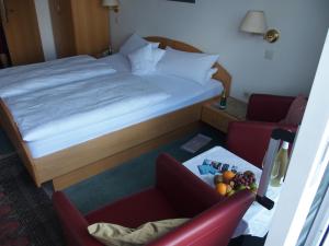 Postel nebo postele na pokoji v ubytování Hotel Pension Café Hasler