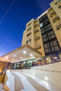 a building with a staircase in front of it at Marinas Maceió Hotel in Maceió