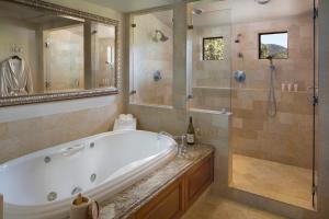 a bathroom with a tub, sink, and bathtub at Napa Valley Lodge in Yountville