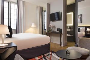 a hotel room with a large bed and a living room at Boutique Hotel Des XV in Strasbourg +37 photos