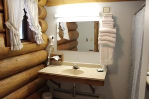 a bathroom with a sink and a mirror at Nootka Lodge in Woodsville +81 photos