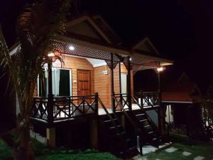 a house with a deck at night at Perhentian Island Cocohut Long Beach Resort in Perhentian Island