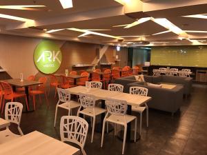 a restaurant with tables and chairs and a couch at Ark Hotel - Changan Fuxing方舟商業股份有限公司 in Taipei