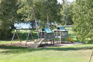 two childrens playground equipment in a park at Colonial Bay Motel and Cottages in Huntsville