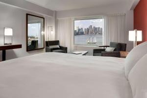 a hotel room with two beds and a large window at Hyatt Regency Boston Harbor in Boston