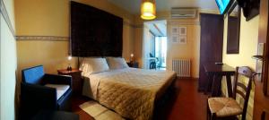 a hotel room with a bed and a chair at Agriturismo Colomboni in San Costanzo +15 photos
