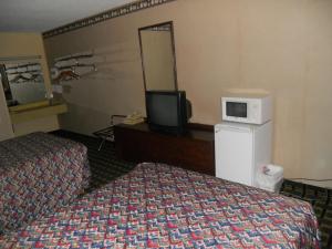 מיטה או מיטות בחדר ב-Arcola Inn