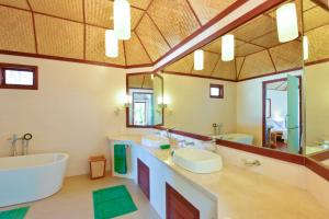 a bathroom with two sinks and a large mirror at Thulhagiri Island Resort & Spa in North Male Atoll