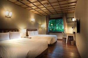 A bed or beds in a room at Chilan Hotel