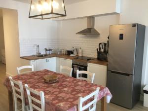 a kitchen with a table and a refrigerator at apartment Seaside in Blankenberge
