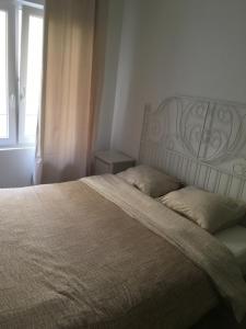 a bedroom with a large bed with a window at apartment Seaside in Blankenberge