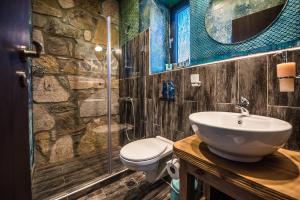 a bathroom with a sink and a toilet at Keros Blue - Luxury in Wilderness in Kalliópi