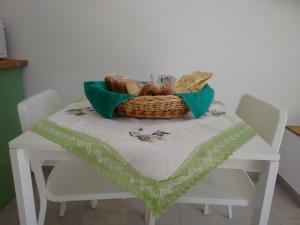 a picnic table with a basket on top of it at Casa Lucrino in Pozzuoli