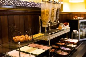 a buffet line with pastries and other food items at Hotel Abanico in Seville