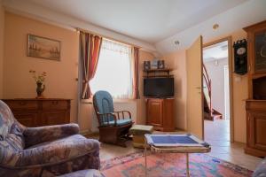 a living room with a couch and a table at Apartma Franko in Cerklje na Gorenjskem