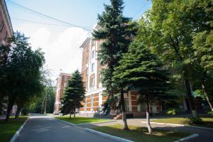 an empty street in front of a building with trees at Tourist Hotel in Moscow