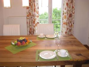 a dining room table with a bowl of fruit on it at Ferienwohnung Damkröger 2 in Lindau