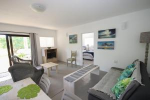 a living room with a couch and a table at Moonriver Self Catering in Plettenberg Bay