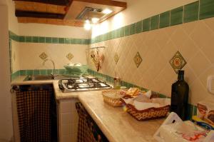 a kitchen with a stove top oven and a counter top at Poderone Vecchio in Sorano