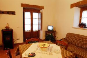 a living room with a table and a couch at Poderone Vecchio in Sorano