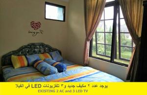 a bedroom with a bed and a window at Villa Kota Bunga NA2 in Puncak +83 photos