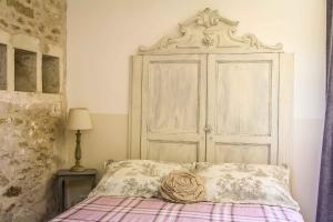 a bedroom with a bed with a large white door at Le Clos du Vallon des Courances in Saint-Coutant-le-Grand