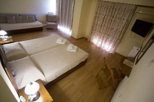 Voodi või voodid majutusasutuse Hotel Cronos toas