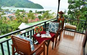 uma varanda com uma mesa e cadeiras e uma vista em Phi Phi Arboreal Resort em Phi Phi Don